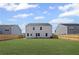 Large backyard with green grass surrounded by a wooden fence, showing the home's exterior at 313 Foxglove Way, Mcdonough, GA 30253