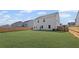 Wide shot of a large, grassy backyard with a wooden fence and the back of the home at 313 Foxglove Way, Mcdonough, GA 30253