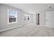 Bright bedroom with carpeted floors and ample natural light from the two windows at 313 Foxglove Way, Mcdonough, GA 30253