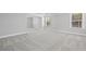 Spacious bedroom featuring plush carpeting, natural light from windows, and neutral paint at 313 Foxglove Way, Mcdonough, GA 30253