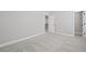 Bedroom showcasing gray carpet flooring and white trim with doorway views to an adjacent room at 313 Foxglove Way, Mcdonough, GA 30253