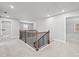 Upstairs hallway leading to bedrooms with wood railing at 313 Foxglove Way, Mcdonough, GA 30253