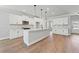 Modern kitchen featuring white cabinets, a center island, stainless steel appliances, and wood flooring at 313 Foxglove Way, Mcdonough, GA 30253