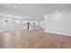 Bright open living space featuring wood floors, recessed lighting, and adjacent kitchen area at 313 Foxglove Way, Mcdonough, GA 30253