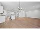 A spacious, open-concept living area featuring wood flooring, recessed lighting, and kitchen view at 313 Foxglove Way, Mcdonough, GA 30253