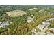 Aerial view of community with houses and green spaces at 9680 Almaviva Dr, Alpharetta, GA 30022