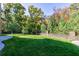 Large backyard with lush lawn and brick wall at 9680 Almaviva Dr, Alpharetta, GA 30022