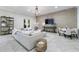 Spacious basement with a large sectional sofa, herringbone floors, and a stone accent wall at 9680 Almaviva Dr, Alpharetta, GA 30022