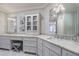 Elegant bathroom boasts double vanities, a large mirror, and a built-in cabinet at 9680 Almaviva Dr, Alpharetta, GA 30022