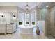 Spa-like bathroom with soaking tub, walk-in shower, and marble finishes at 9680 Almaviva Dr, Alpharetta, GA 30022