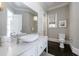 Elegant powder room featuring a white vessel sink and marble vanity at 9680 Almaviva Dr, Alpharetta, GA 30022