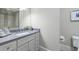 Modern bathroom with gray vanity and shower at 9680 Almaviva Dr, Alpharetta, GA 30022