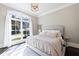 Spacious primary bedroom with large window and ample natural light at 9680 Almaviva Dr, Alpharetta, GA 30022