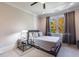 Bright bedroom with a queen bed and large window at 9680 Almaviva Dr, Alpharetta, GA 30022
