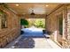 Covered patio with stone flooring and view of backyard at 9680 Almaviva Dr, Alpharetta, GA 30022