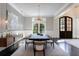 Formal dining room with modern chandelier and large windows at 9680 Almaviva Dr, Alpharetta, GA 30022