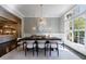 Formal dining room with modern chandelier and large windows at 9680 Almaviva Dr, Alpharetta, GA 30022