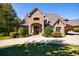 Brick home with landscaped yard and driveway at 9680 Almaviva Dr, Alpharetta, GA 30022