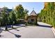 Gated community entrance with guard house and landscaping at 9680 Almaviva Dr, Alpharetta, GA 30022