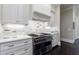 Luxury kitchen with high-end stainless steel appliances and marble backsplash at 9680 Almaviva Dr, Alpharetta, GA 30022