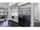 Modern kitchen featuring a stainless steel refrigerator and white cabinetry at 9680 Almaviva Dr, Alpharetta, GA 30022