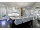 Gourmet kitchen boasting a spacious island with seating and granite countertops at 9680 Almaviva Dr, Alpharetta, GA 30022