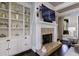 Spacious living room with a cozy fireplace and built-in shelving at 9680 Almaviva Dr, Alpharetta, GA 30022