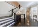 Grand staircase with dark hardwood floors and white railings at 9680 Almaviva Dr, Alpharetta, GA 30022
