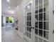 Walk-in wine cellar with glass doors showcasing an extensive wine collection at 9680 Almaviva Dr, Alpharetta, GA 30022