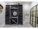 Modern wine cellar with ample storage, a stylish mirror, and an arched entry at 9680 Almaviva Dr, Alpharetta, GA 30022