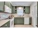 Modern kitchen with green cabinets, white appliances, and ample counter space at 2737 Mount Olive Dr, Decatur, GA 30033