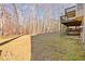 Large backyard with a deck and wooded area at 3405 Sweetwater Dr, Cumming, GA 30041