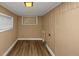 Finished basement room with neutral walls and wood-look flooring at 1881 Broad Ave, East Point, GA 30344