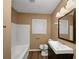 Clean bathroom with a white tub and dark vanity at 1881 Broad Ave, East Point, GA 30344