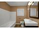 Clean bathroom with a white tub and dark vanity at 1881 Broad Ave, East Point, GA 30344