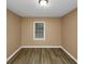 Simple bedroom with neutral walls and wood-look flooring at 1881 Broad Ave, East Point, GA 30344