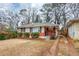 Brick ranch home with a well-maintained lawn at 1881 Broad Ave, East Point, GA 30344