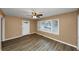Living room with new flooring and ceiling fan at 1881 Broad Ave, East Point, GA 30344