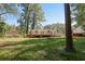 Expansive backyard featuring a wooden deck, lush greenery, and mature trees offering privacy and space for outdoor activities at 1931 Oana Sw St, Atlanta, GA 30310