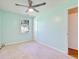 Well-lit bedroom featuring plush carpet, a ceiling fan, and a view from the window at 1931 Oana Sw St, Atlanta, GA 30310