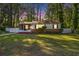 Attractive home with mature landscaping, well-maintained lawn, and inviting front porch at 1931 Oana Sw St, Atlanta, GA 30310
