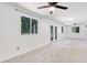 Spacious living room with plush carpet, large windows, and access to a back patio at 1931 Oana Sw St, Atlanta, GA 30310