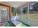 Enclosed porch with screens offering an outdoor seating area with views of the neighborhood at 1931 Oana Sw St, Atlanta, GA 30310