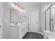 Bathroom features double vanity, framed mirror, and tiled glass shower at 236 Begonia Way, Mcdonough, GA 30253