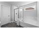 Bathroom featuring shower with glass door and soaking tub with tile surround at 236 Begonia Way, Mcdonough, GA 30253
