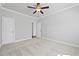 Bright bedroom featuring neutral walls, carpet, ceiling fan and white door at 236 Begonia Way, Mcdonough, GA 30253