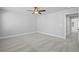 Spacious carpeted bedroom features a ceiling fan, neutral paint, and access to the ensuite bathroom at 236 Begonia Way, Mcdonough, GA 30253