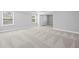 Bedroom with neutral carpet and paint, tray ceiling, and natural light at 236 Begonia Way, Mcdonough, GA 30253