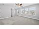 Bright bedroom featuring windows with blinds, neutral walls, carpet, and ceiling fan at 236 Begonia Way, Mcdonough, GA 30253