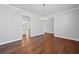 Elegant dining room featuring hardwood floors, crown molding, and modern chandelier lighting fixture at 236 Begonia Way, Mcdonough, GA 30253